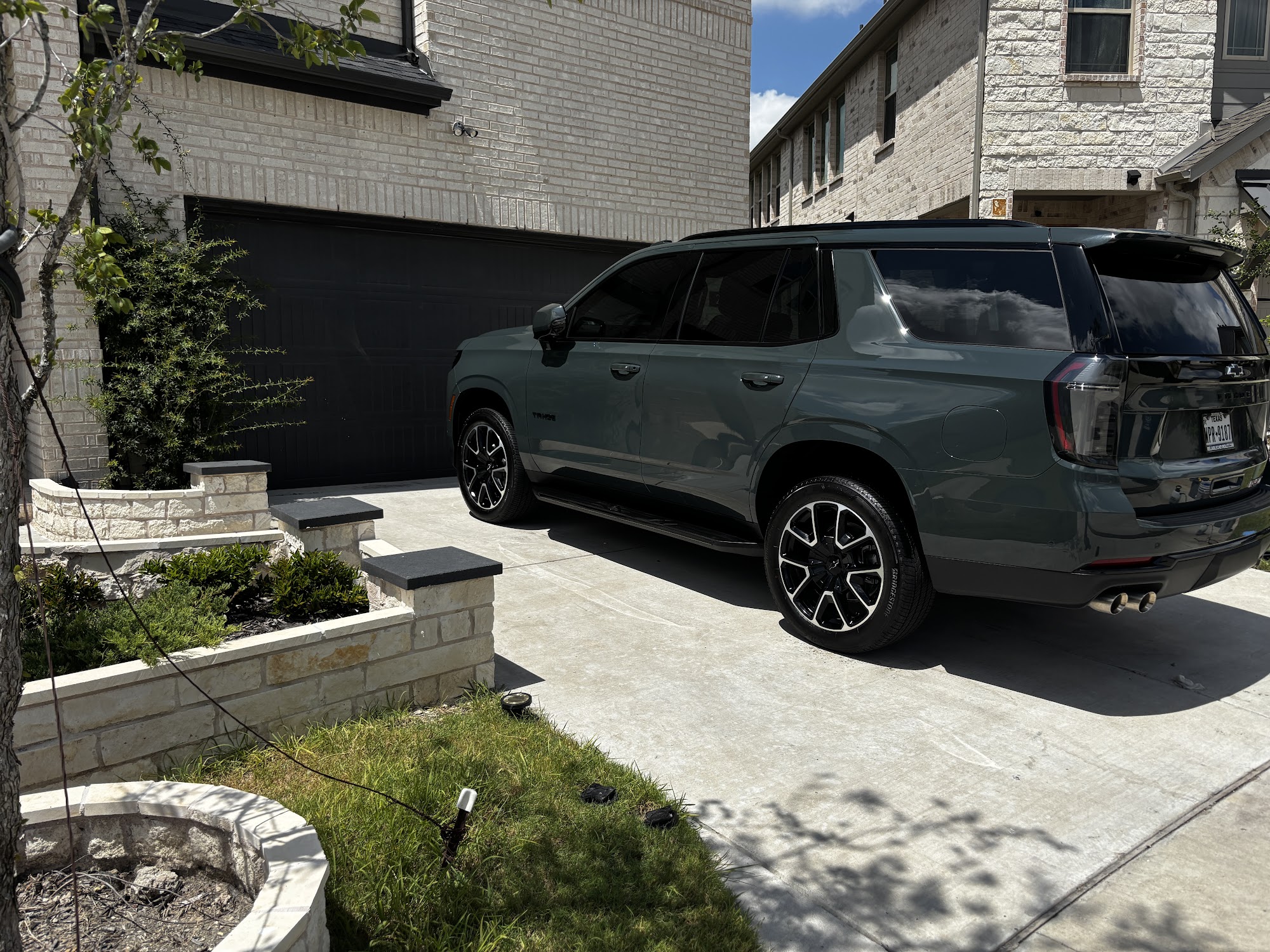 Freshly detailed vehicle parked in a driveway after a full interior and exterior detail